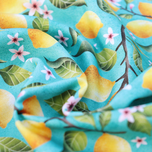 Tessuto in Raso di 100% Cotone: Limoni su sfondo Turchese