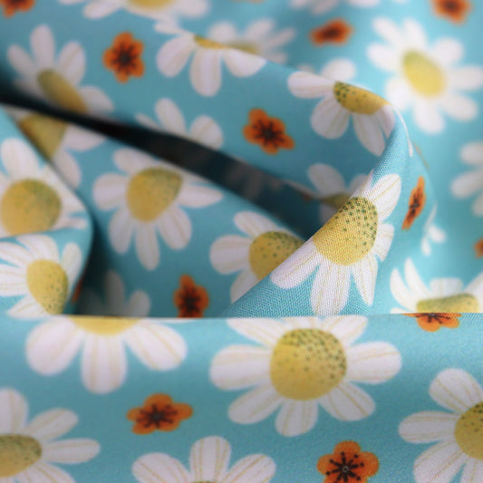 Tessuto SOFTSHELL impermeabile: Margherite bianche su sfondo turchese