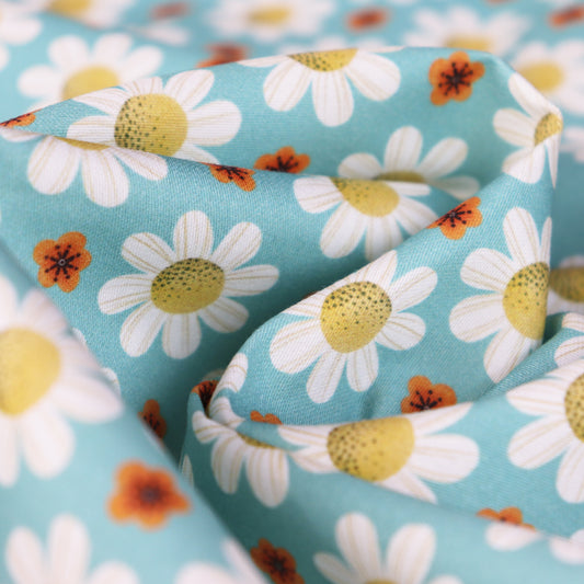 Tessuto in Raso di 100% Cotone: Margherite su sfondo Celeste